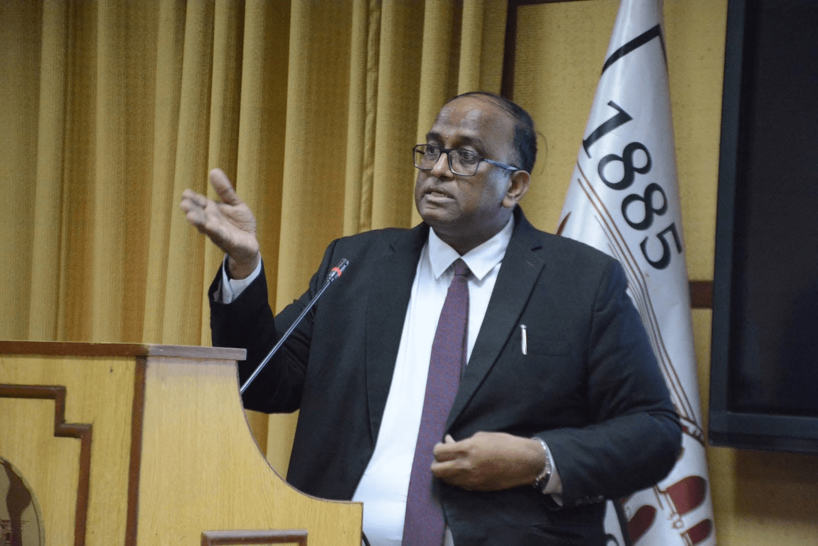 Ghulam Shabbir Babar speaking at a university podium